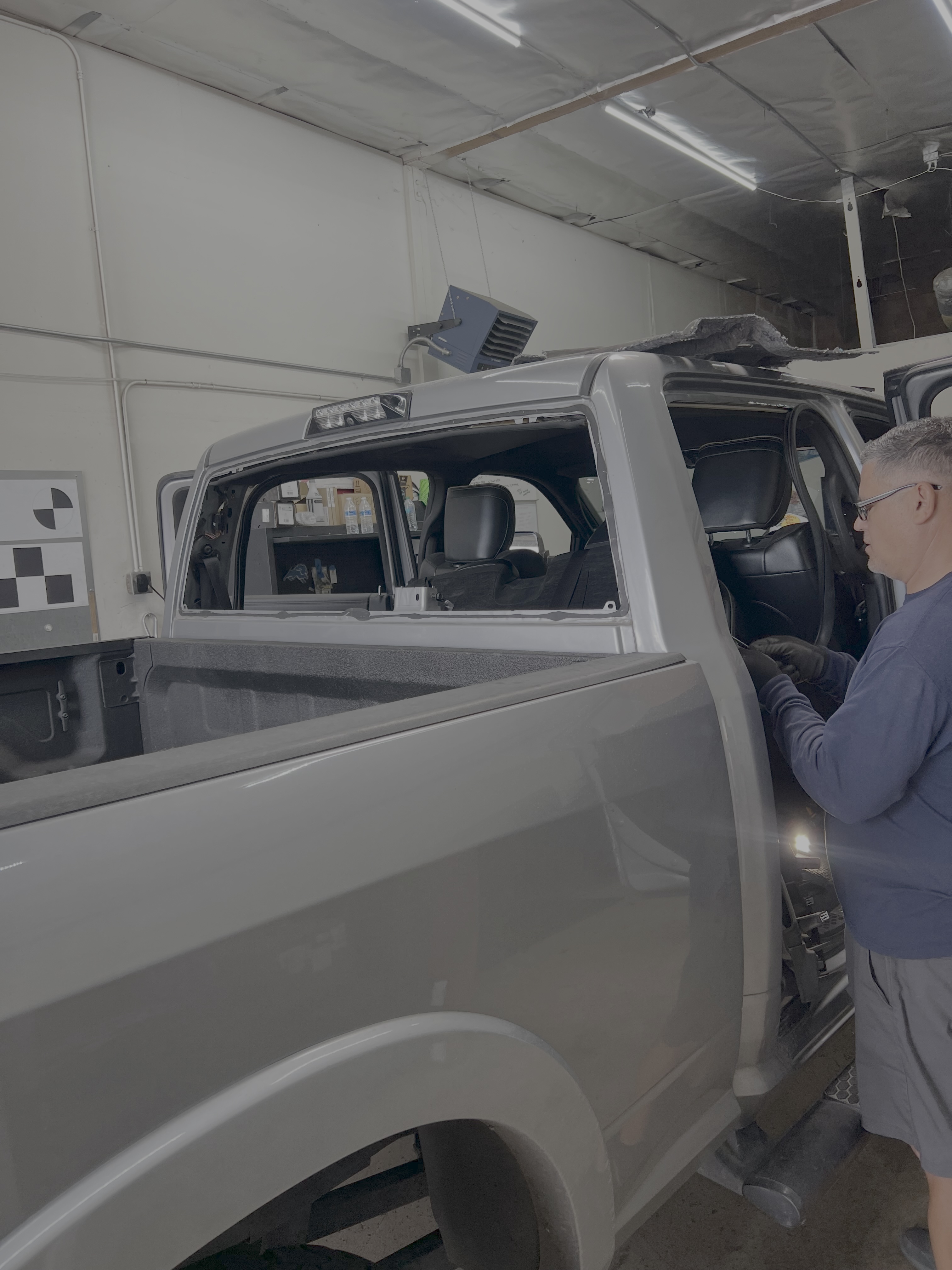 Shelby Auto Glass technician replacing side and rear vehicle glass